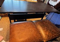 Top view of table and part of stool seat showing wear