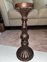 Full view of dark brown pedestal candle holder front