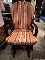 Front view of wooden rocking chair with striped cushions