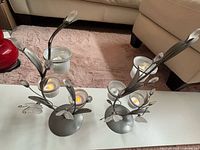 pair of metal butterfly candle holders with six LED tealights placed in cups