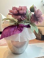 Vase with artificial flowers inserted