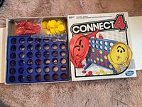 Open box showing blue grid, red and yellow checkers bags and box lid
