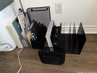 Group shot of desk organizers, notebooks, punch, stapler, clipboard, rulers