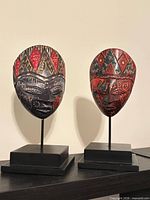 Front view of both batik wooden masks on stands