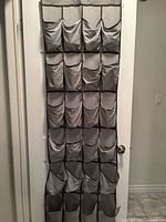 Over-door 24-pocket shoe organizer hanging on door