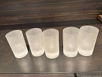 Front view of all five frosted shot glasses side by side