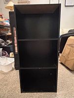 Front view of black 3-tier shelf showing overall structure