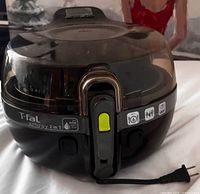 Front view of T-fal Actifry showing brand label, lid latch and power cord