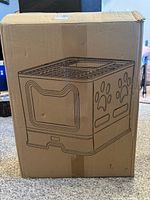 Sealed shipping box with line art of Vealind enclosed litter box