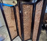 Angled view showing four connected panels, wood frames, rattan weave