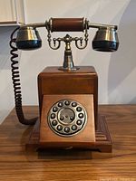 Front view showing rotary-style dial and handset