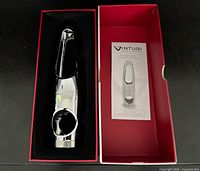 Open box showing metal Vinturi champagne opener and instruction leaflet