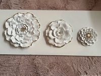 Front view showing three ceramic flowers lined up