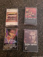 All four cassette tapes with cases front view