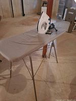 Ironing board with iron placed on top