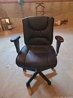 Front view of black faux leather office chair showing seat, backrest and armrests
