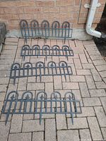 Four edging panels laid on brick paving showing overall design and stakes