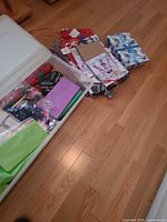 Open plastic tub showing assorted gift bags and tissue paper