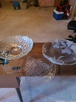Overview of all three clear pressed glass pieces on table