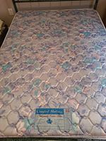 Top view of mattress showing floral quilted surface and Comfort Mattress Orthopaedic Extra Firm label
