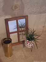 Mirror, brass stand and planter grouped