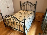 full view of assembled bed frame with bedding showing headboard and footboard