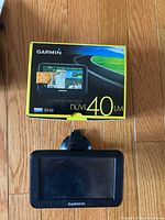 Front view of Garmin nüvi 40LM GPS on mount with box