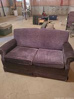 Front view of purple loveseat sleeper sofa showing seat and arm style