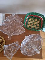 Clear glass plates, wicker basket, brass trivet