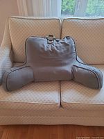 Front view of khaki green backrest pillow on sofa