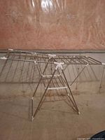 Full view of stainless steel folding drying rack fully extended