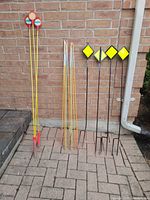 Full lot showing all marker and survey stakes against brick wall