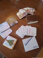 Overview of multiple coaster stacks and two branded boxes on table