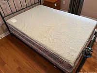 Top view of Nikken Ultra Kenkopad mattress topper on full bed frame