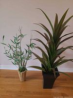 Both artificial plants side by side showing relative size and pots