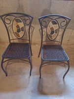 Front view of both chairs showing woven seats and mosaic back inserts