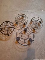 Group shot of four metal plant supports showing two design types