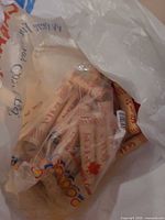 bag containing multiple beige printed coin wrappers