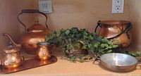 Group shot of all copper pieces arranged on shelf