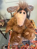 Full view of ALF plush seated on chair showing overall appearance