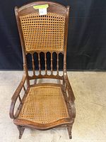 Front view showing cane seat and back, spindle details