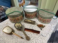 Three matching hat boxes with vanity items displayed