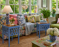 In-use inspirational image showing similar blue lattice tables beside floral sofa (seller notes illustration only)