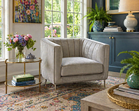 Front angled view of grey velvet barrel chair with channel tufting and chrome legs