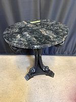 Round table angled view showing faux-marble top surface