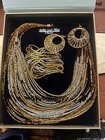 Full boxed set showing necklace, earrings, bracelet