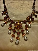 Full view of vintage floral rhinestone necklace laid flat
