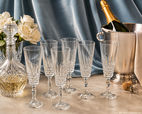Full set of six cut crystal champagne flutes displayed with decanter and ice bucket