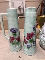 Two tall Radford jugs showing floral design and form