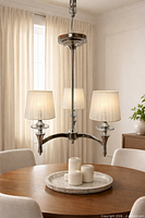 Chandelier installed in dining setting showing overall design and shades illuminated